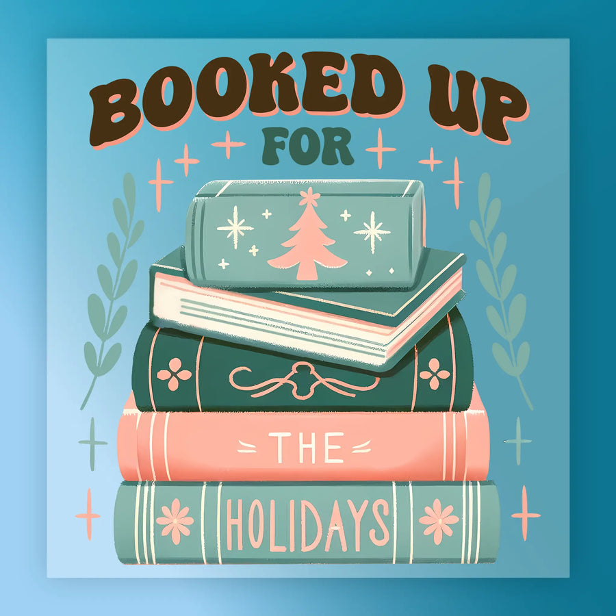 The "Booked Up The Holidays Design - Heat Press Ready" by InkMerge shows a festive book stack topped with a Christmas tree, “The Holidays” on the spines, and accents of leaves and stars—ideal for DTF transfer or heat press projects.