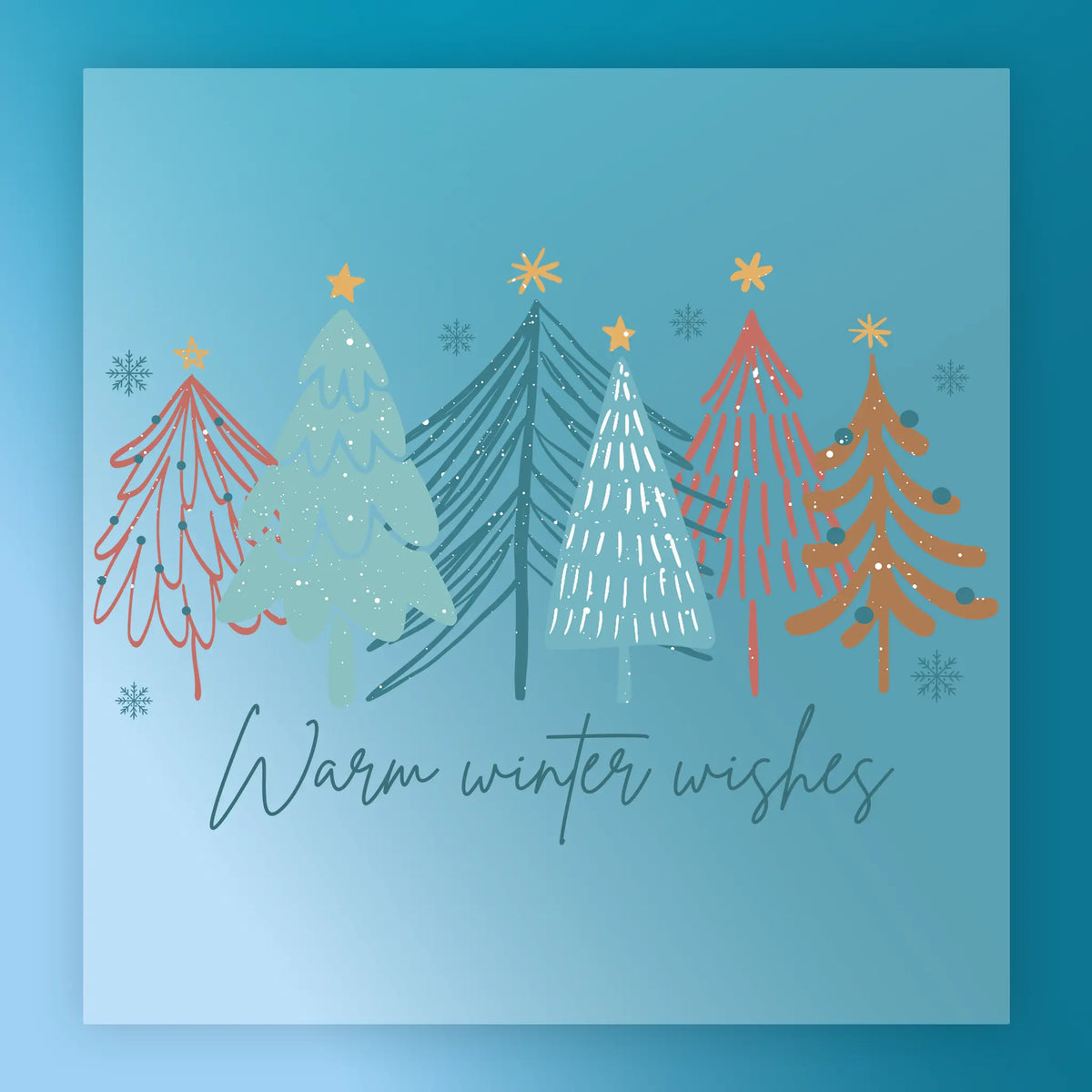 The Warm Winter Wishes Vintage Design by InkMerge features six colorful, stylized Christmas trees on a blue, snowflake background with “Warm winter wishes” below in elegant script, perfect for retro garment transfers.