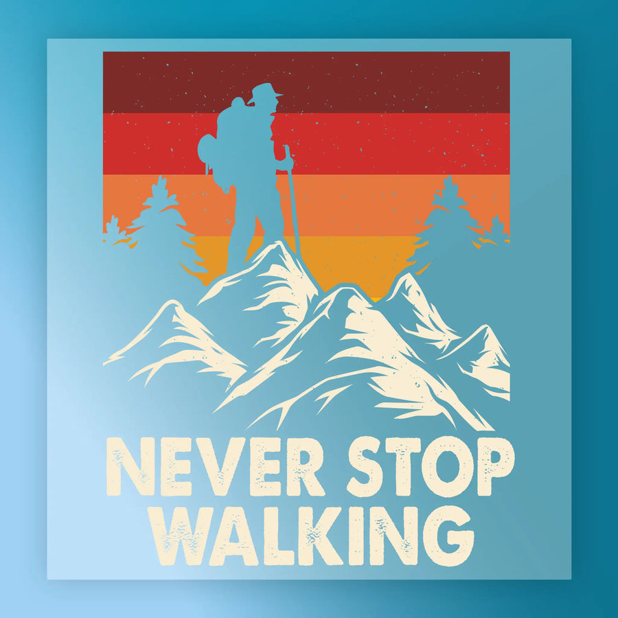 A hiker silhouette with a backpack stands on mountain peaks, surrounded by pines and a retro sunset. The InkMerge Retro Mountain Sunset Design DTF transfer features bold “NEVER STOP WALKING” text, perfect for heat press application.
