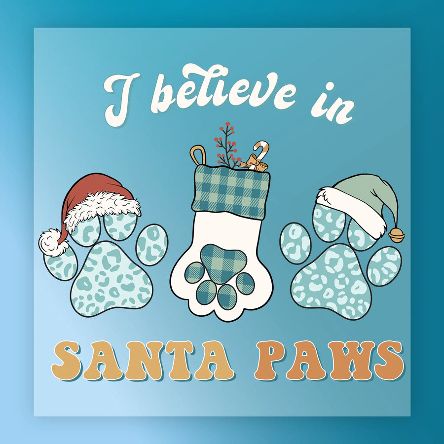 The InkMerge "I Believe In Santa Paws Design" features a blue background, Santa-hat paw prints, and a plaid stocking with festive accents—ideal for ugly sweater parties or as a merry DTF transfer.