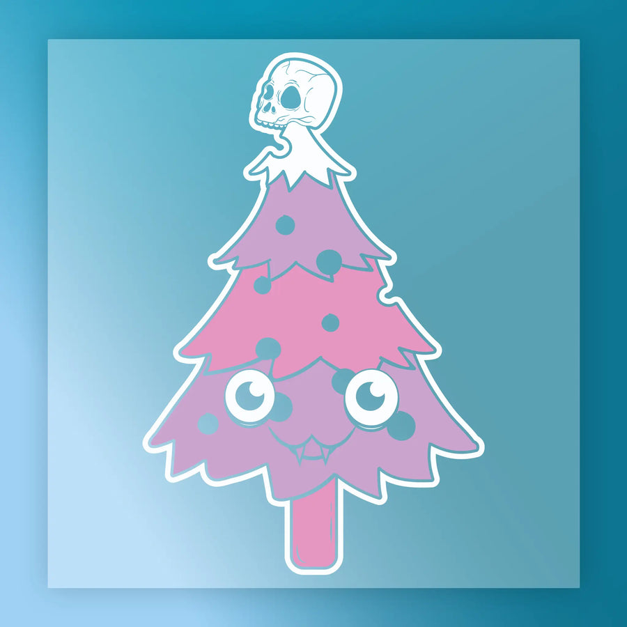 The InkMerge Gothic Christmas Tree with Skull Ornaments DTF transfer features a cartoon-style pink and purple tree with big eyes, a smiling mouth, skull ornaments, and a white skull topper on a blue gradient background.
