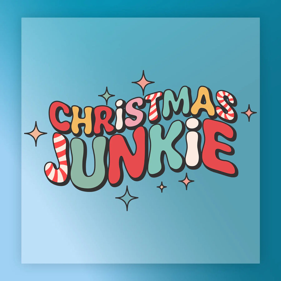 The CHRISTMAS JUNKIE Festive Design by InkMerge features vibrant, candy cane-inspired lettering with stars on a blue background—ideal for holiday heat press transfers.