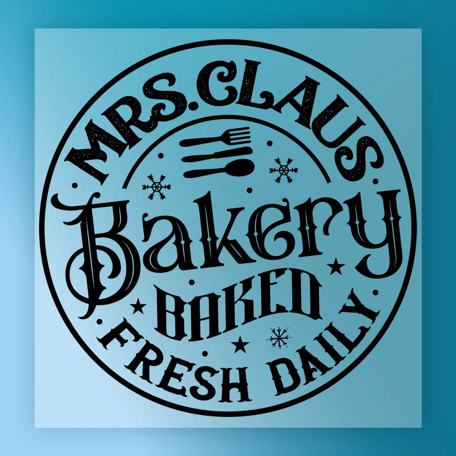 The Mrs. Claus Bakery Vintage Design by InkMerge features black text and decorative snowflakes with utensils on a light blue background—ideal for vintage design transfers or custom apparel.