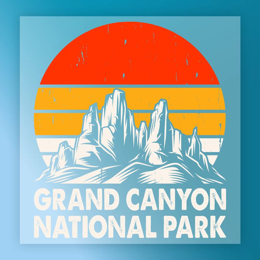 The InkMerge Retro Desert Sunset Adventure DTF transfer features a stylized illustration of rocky mountain peaks and a retro orange-yellow striped sun, with “Grand Canyon National Park” in bold white letters beneath.