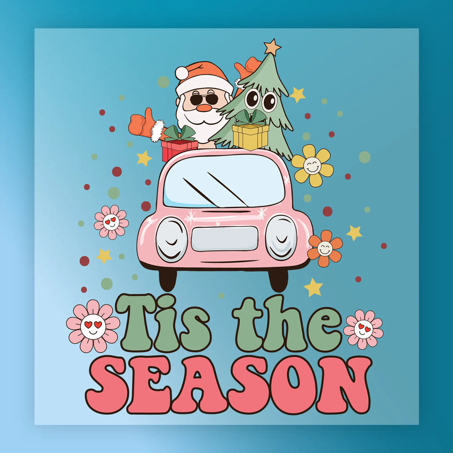 Cartoon Santa and a Christmas tree with gifts ride in a pink car decorated with flowers, stars, and dots. Large “Tis the SEASON” text on blue makes InkMerge’s Holiday Shirt Design perfect for custom apparel or festive DTF heat press transfers!.