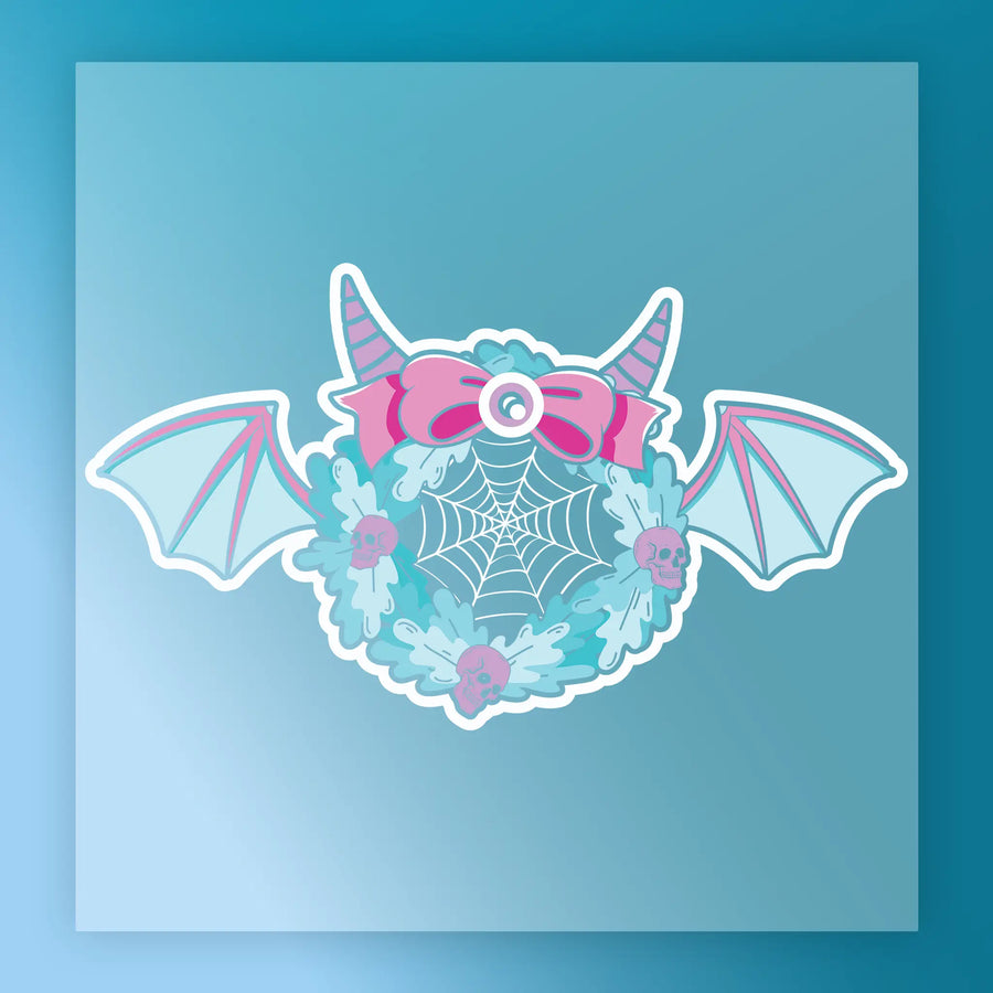 The InkMerge Kawaii Goth Wreath with Skulls and Bow features pastel blue, bat wings, pink horns, a bow, spider web center, and pink skulls—ideal for Kawaii Goth DTF transfer projects or premium DTF film heat press designs.