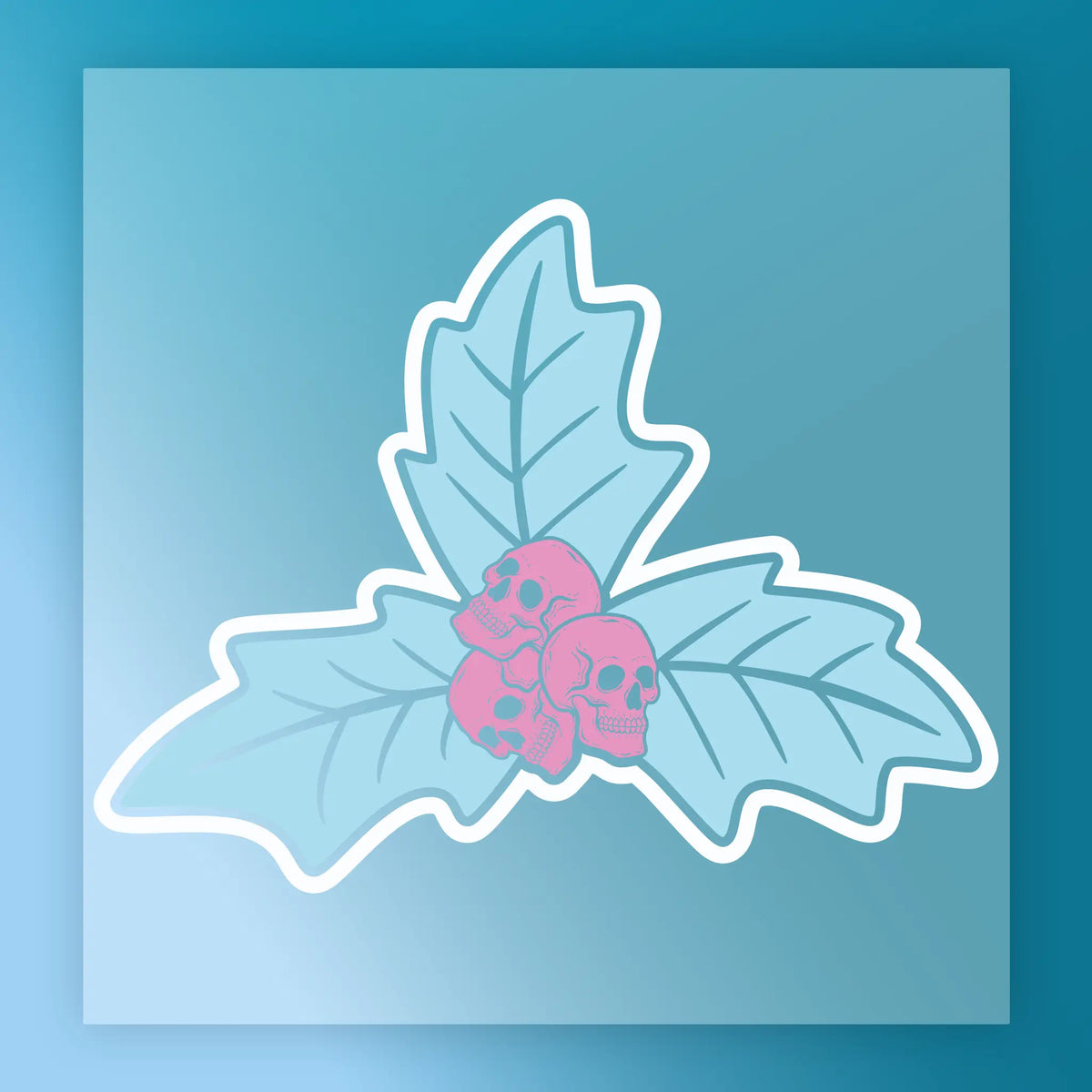 The InkMerge "Gothic Pink Skulls on Holly" transfer features two crossed blue leaves and three pink skulls at their intersection, set on a blue background with a white border—ideal for adding bold, custom flair to your apparel.