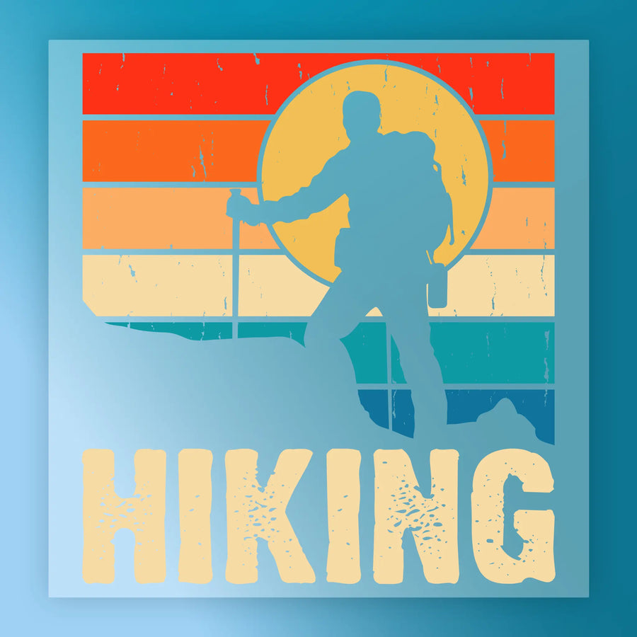 A hiker silhouette with backpack and stick stands on a mountain before a retro sunset of red, orange, yellow, and blue stripes. Ideal for heat press transfer or InkMerge Retro Surfing Sunset DTF projects. Large text below reads HIKING.