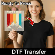 A woman holding a sign with a mountain landscape and the text "Take a Hike" on it, with a red arrow pointing to her chest.