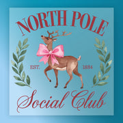 The InkMerge North Pole Social Club Reindeer Design shows a reindeer with a pink bow and green leaves, plus "NORTH POLE Social Club" and "EST. 1884" on blue—ideal for festive holiday shirt transfers.