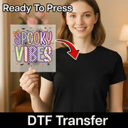 A woman is holding up a sign with the text "SPOOKY VIBES" in front of her.