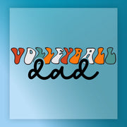 a vibrant and playful design with the word "Volleyball" written in a stylized font, accompanied by the word "dad" in a handwritten, cursive style.