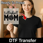 A smiling woman holding a sign that says "Volleyball Mom" with a red arrow pointing to it.