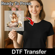 A smiling woman in a black shirt holds a sheet featuring InkMerge's Angelic Candlelight Serenity DTF transfer, candles, and flowers. “Ready To Press” tops the sheet; “DTF Transfer” and a red arrow point at the shirt—ideal for your heat press.
