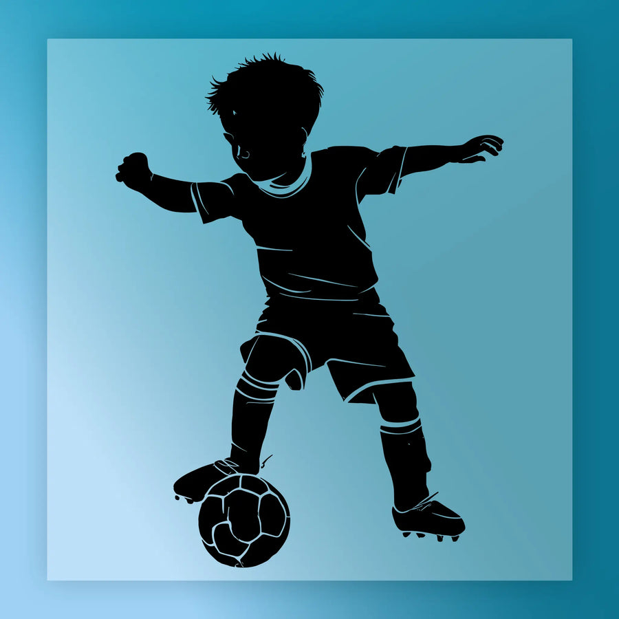 A silhouette of a young boy playing soccer, with his arms outstretched and a soccer ball in front of him.