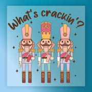 InkMerge's "What's Crackin' Nutcracker Humor" features three vibrant nutcracker soldiers in tall hats, each holding a nut beneath playful text and scattered stars—a festive, funny design ideal for your holiday heat press projects.