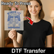 A woman in a black shirt smiles while holding an InkMerge Grumpy Holiday Humor Design DTF transfer, with an arrow pointing to her shirt. Text reads Ready To Press, DTF Transfer, perfect for use with your heat press.