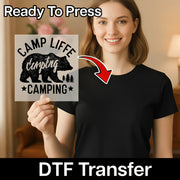 A woman in a black t-shirt holds an InkMerge Mama Bear Silhouette Design transfer sheet with a bear print. An arrow points from the sheet to her shirt. Text reads “Ready To Press” and “DTF Transfer”—ideal for custom apparel.