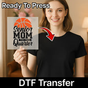 A woman holding a sign with the text "Ready To Press Senior Mom The Final Quarter" and a red arrow pointing to her chest.