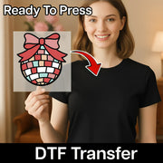A smiling woman holds an InkMerge DTF transfer sheet featuring the Patchwork Ornament Design. An arrow points to her black shirt, ready for the heat press. Text reads “Ready To Press” and “DTF Transfer.”.