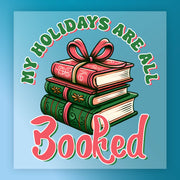 InkMerge's "My Holidays Are All Booked" design features three stacked books with festive patterns and a big bow, plus holiday text in green and red on a blue background—ideal for heat press or DTF transfer projects.