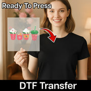 A smiling woman in a black shirt holds a clear InkMerge Festive Holiday Drinks Design DTF transfer. "Ready To Press" is at the top and "Direct-to-Film transfer" at the bottom, with a red arrow pointing to the sheet.