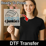 A woman is holding up a sign with the text "volleyball junky" on it, and there is a red arrow pointing to the sign.