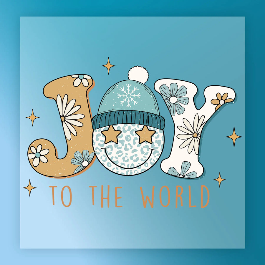 InkMerge’s Joy To The World Design features “JOY” with floral motifs; the “O” is a blue leopard-print smiley in a winter hat with star eyes. “TO THE WORLD” appears orange on blue. Great for decorating garments via DTF transfer or heat press.