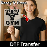 A woman holding a sign with a gym logo on it, smiling and posing for the camera.