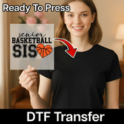 A woman holding a sign with the text "Ready To Press senior basketball SIS" and an arrow pointing to the sign.