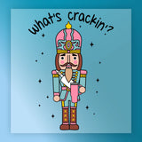 The Nutcracker Soldier Christmas Design by InkMerge showcases a vibrant cartoon soldier in uniform with "what's crackin?" above, surrounded by black stars on a blue gradient—ideal for festive heat press transfer projects.