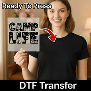 A woman in a black shirt holds an InkMerge Camp Life Silhouette Design DTF transfer with camping icons. "Ready to Press" appears at the top, "DTF Transfer" at the bottom, highlighted by a red arrow pointing to the design.