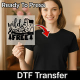 A woman holding a sign with the text "wild & free" on it, with a red arrow pointing to the sign.