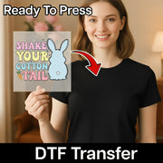 A woman holding a sign with a cartoon rabbit and the text "SHAKE YOUR COTTON TAIL" on it, with a red arrow pointing to her chest.