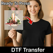 A smiling woman holds InkMerge’s Traditional Holiday Candle Illustration - Heat Press Ready DTF sheet with pinecones, holly berries, and greenery. Text reads: Ready To Press DTF Transfer—ideal for custom apparel.