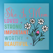 The image is a colorful graphic with text and illustrations. The text reads "She Is Mom" and "Loved, Strong, Important, Worthy, Beautiful". The illustrations include flowers and stars. The overall design is vibrant and cheerful, conveying a positive message.