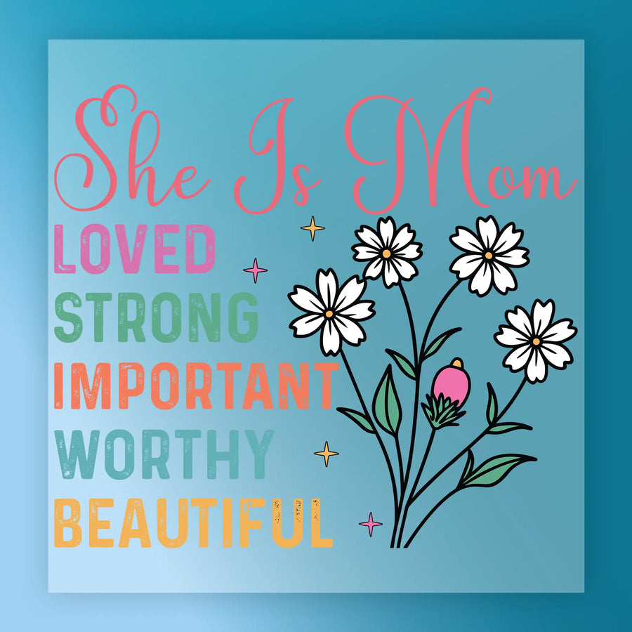 The image is a colorful graphic with text and illustrations. The text reads "She Is Mom" and "Loved, Strong, Important, Worthy, Beautiful". The illustrations include flowers and stars. The overall design is vibrant and cheerful, conveying a positive message.