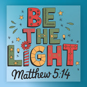 InkMerge's BE THE LIGHT Matthew 5:14 - Heat Press Ready features colorful text, stars, and light bulbs on a blue background with a script citation—ideal for DTF or heat press projects that inspire positivity.