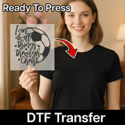 A woman holding a sign with a soccer ball and the text "I can do all things through Christ" on it, with a red arrow pointing to her chest.