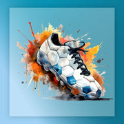 A white and blue soccer cleat with a black lacing system is depicted in the center of the image, surrounded by splashes of orange and yellow paint against a blue background.