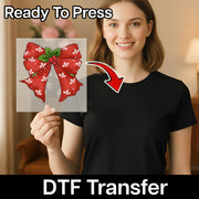 A woman in a black shirt holds InkMerge’s Festive Red Bow with Holly Design transfer, featuring “Ready To Press” above and “DTF Transfer” below. An arrow shows the easy heat press application from sheet to shirt.