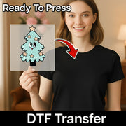A woman holds InkMerge’s Christmas HO HO HO DTF transfer sheet with a cute tree. An arrow points to her plain black shirt. "Ready To Press" is at the top; "Christmas shirt transfer DTF Transfer" is at the bottom.