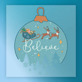 The Believe Christmas Ornament Design by InkMerge features a sleigh with gifts pulled by two reindeer above snowy trees, with "Believe" in script, stars, and snowflakes on a blue background—ideal for heat press or DTF transfer.