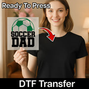 A smiling woman holding a sign with the text "SOCCER DAD" and a red arrow pointing to her chest.