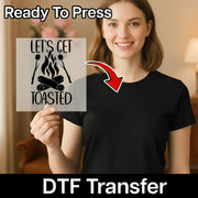 A smiling woman in a black shirt holds an InkMerge "Let's Get Toasted Campfire Humor" transfer sheet with marshmallows and funny text. An arrow points to her shirt. Ready To Press DTF transfers for custom apparel.