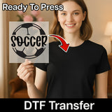 A woman holding a sign with the word "SOCCER" on it, with a red arrow pointing to the sign.