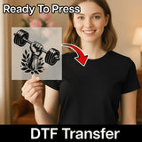A woman holding a transparent sheet with a graphic of a weightlifting symbol, and there is text overlay that says "Ready To Press" and "DTF Transfer".