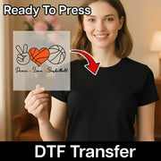 A woman holding a sign with a basketball and heart design, smiling and posing for the camera.