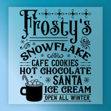 The InkMerge Frosty's Snowflake Cafe Christmas Design reads: "Frosty's Snowflake Cafe. Cookies, Hot Chocolate, Santa, Ice Cream. Open All Winter." Features snowflakes and a hot chocolate mug—ideal for ugly sweater parties! Heat press ready.