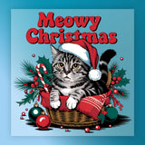 The Meowy Christmas Cat Design by InkMerge features a tabby cat in a Santa hat sitting in a basket with a red blanket, holly, ornaments, and a candy cane—topped with bold "Meowy Christmas" text—perfect for DTF transfers or heat press projects.